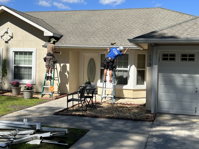 Picture of Doyle installing gutter on a home in Yulee, FL