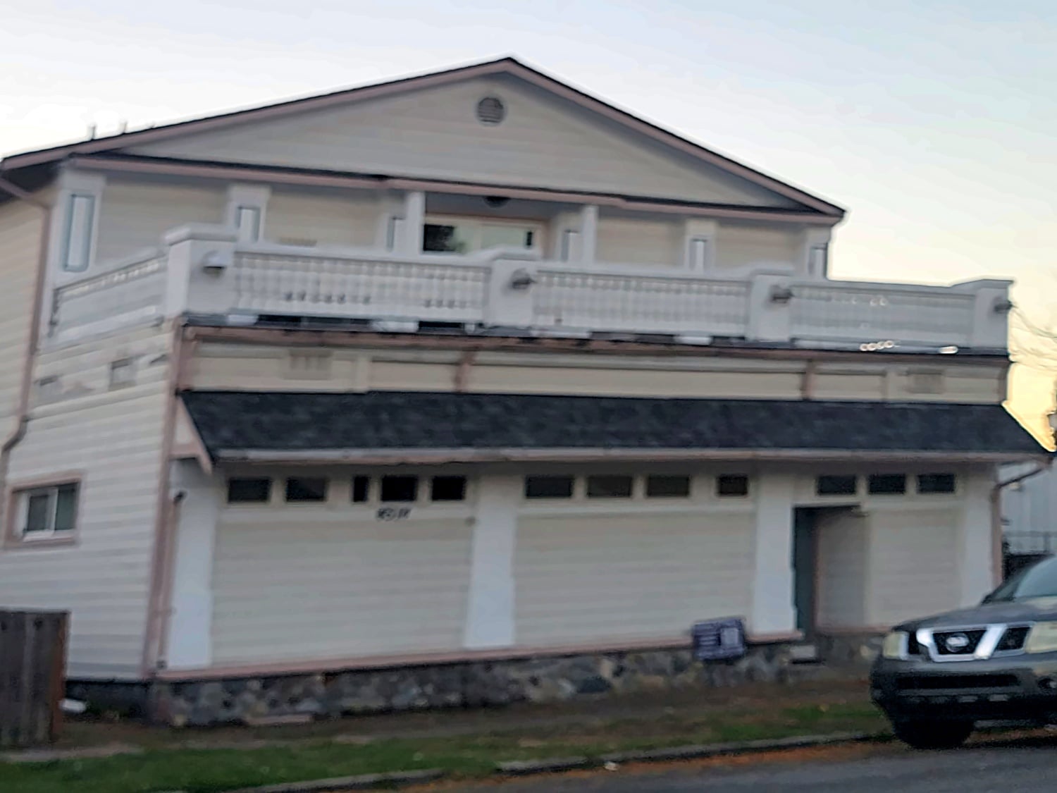 Before: Three-car garage home with balcony
